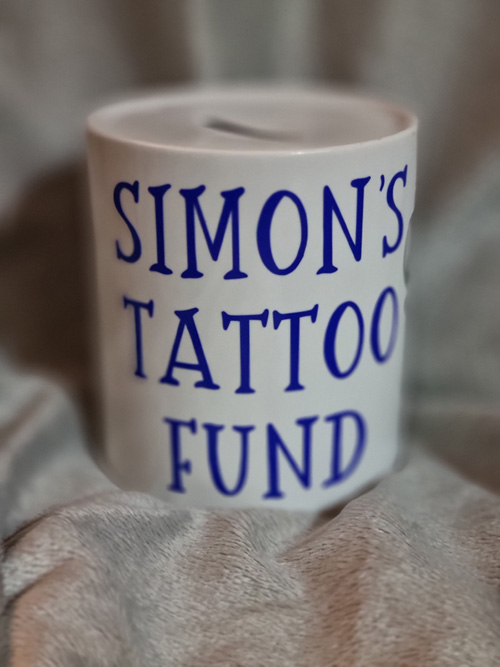 ceramic money box with simon's tattoo fund motive