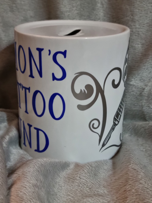 ceramic money box with simon's tattoo fund motive