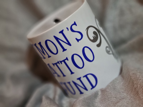 ceramic money box with simon's tattoo fund motive