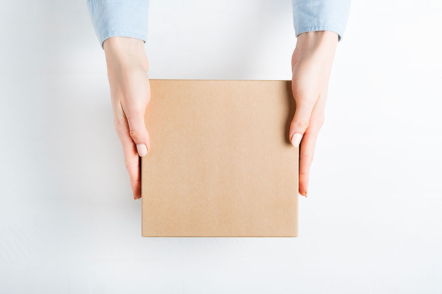 Woman holding cardboard delivery box