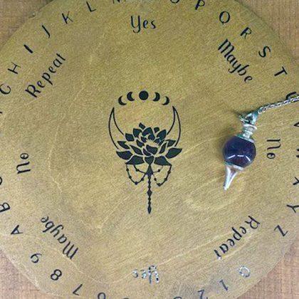 Circularl wooden pendulum board with black vinyl design
